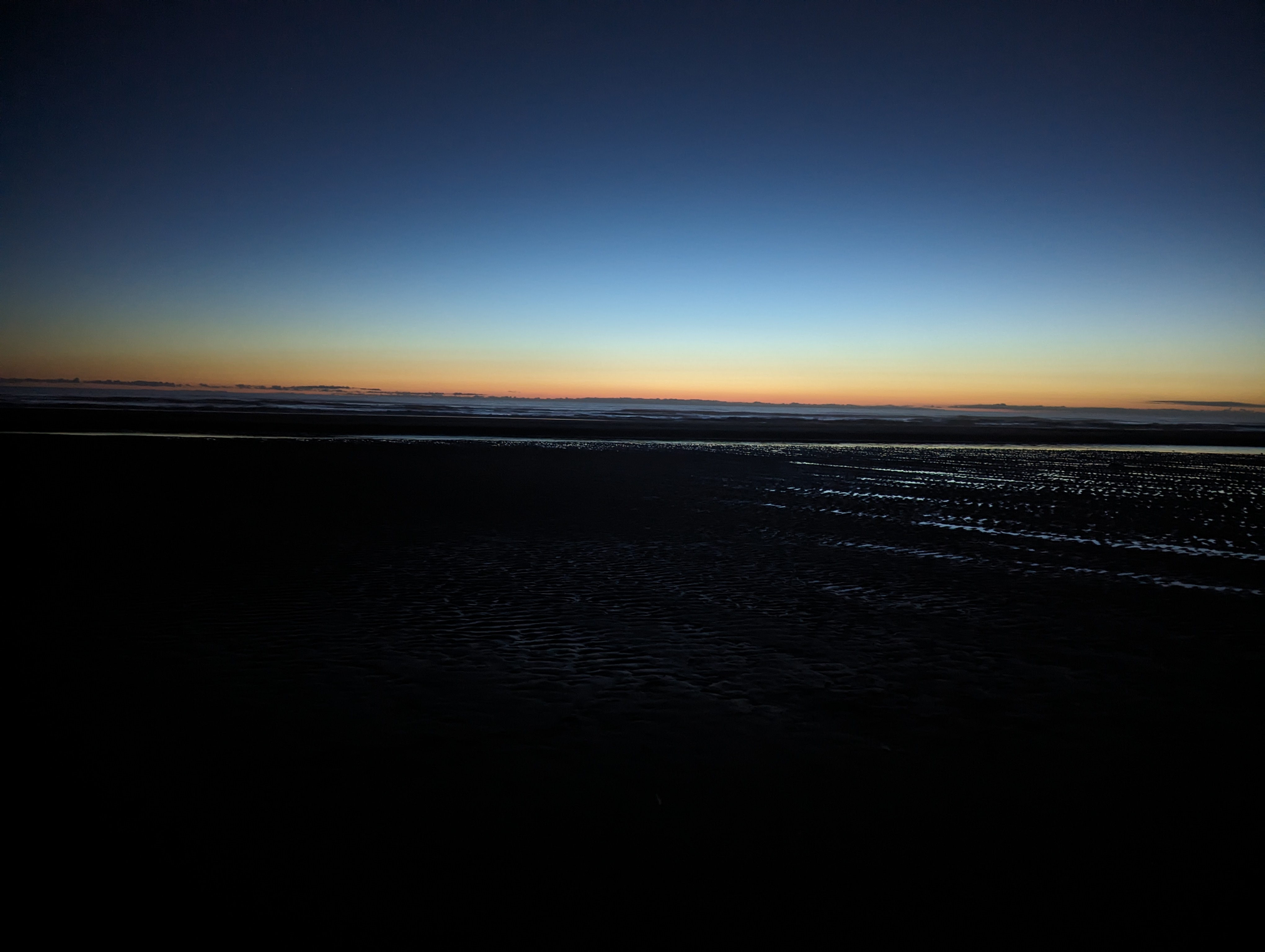 A fiery orange sunset on Long Beach, WA